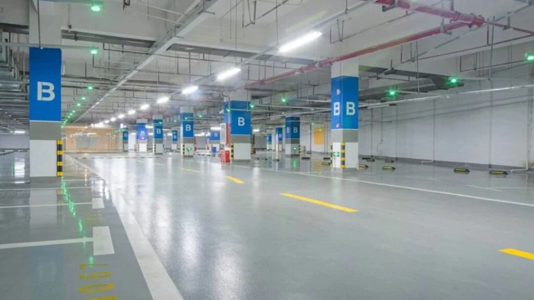 Epoxy flooring in a large commercial parking garage in Saudi Arabia with a glossy finish.