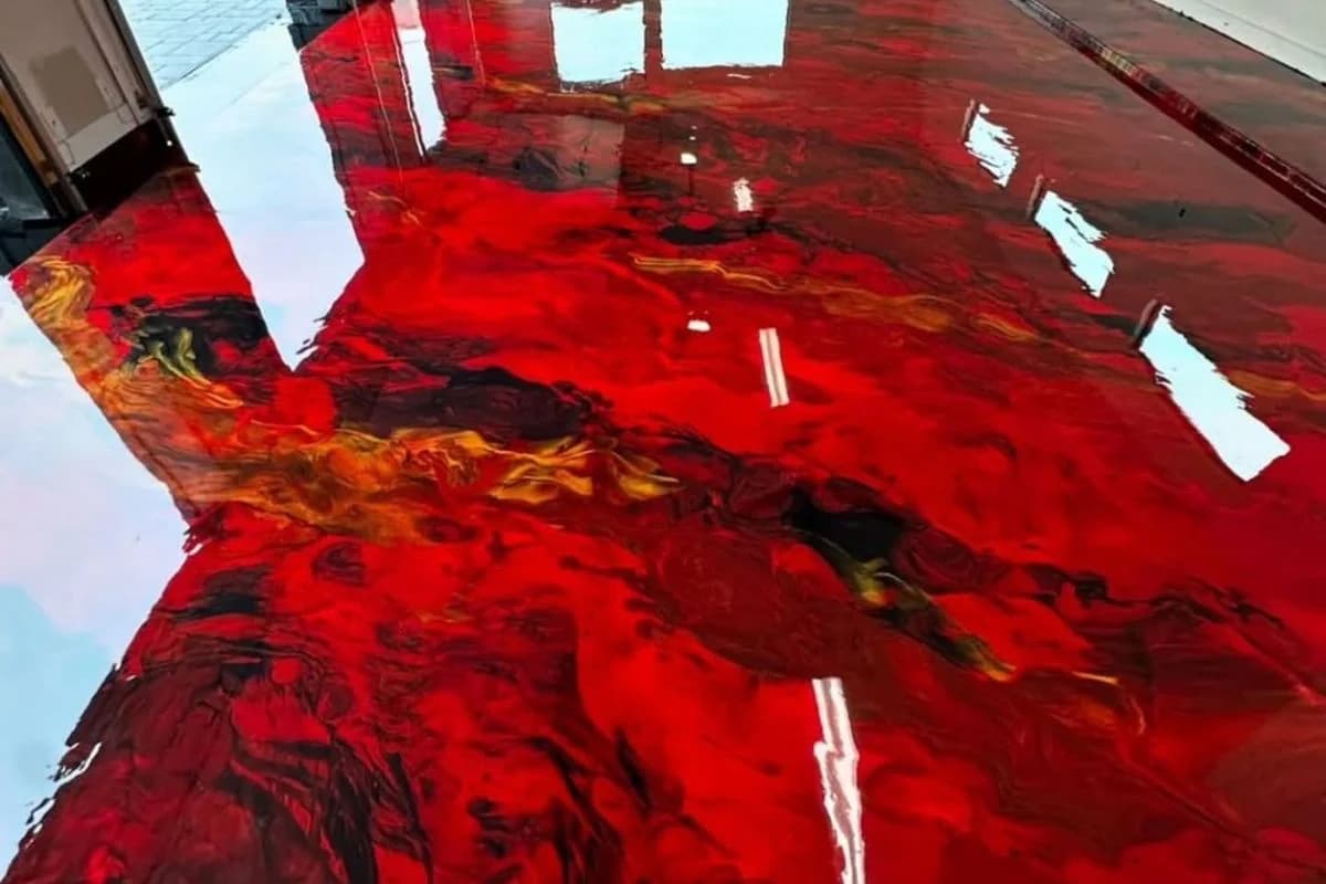 Red metallic epoxy floor design in Dammam showroom