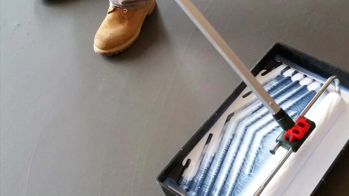 Applying clear sealer topcoat on microcement floor with roller