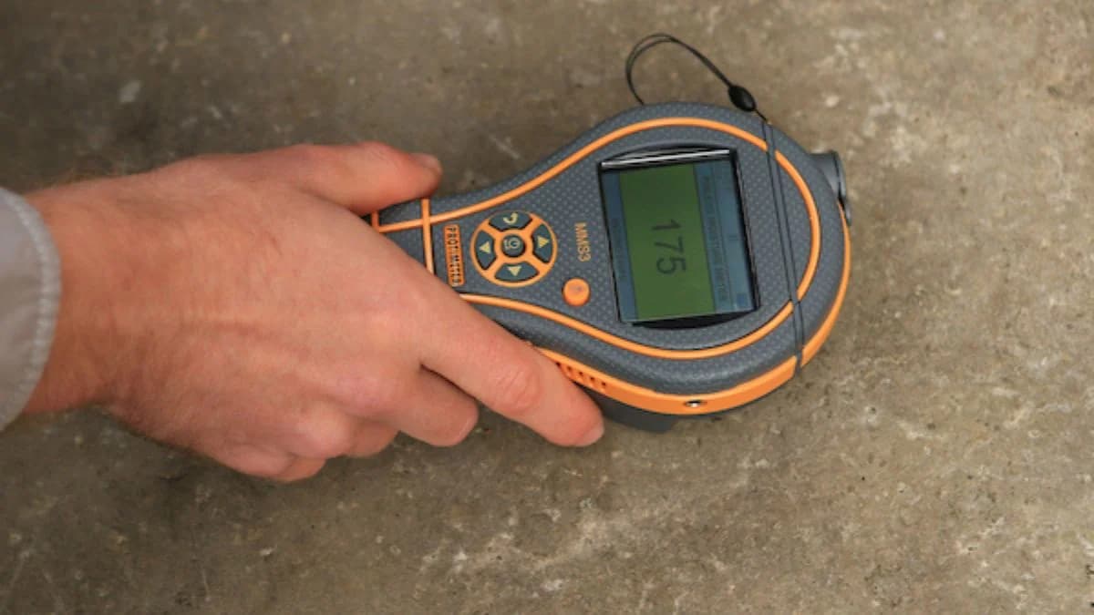 Technician checking concrete moisture during site visit in Saudi Arabia