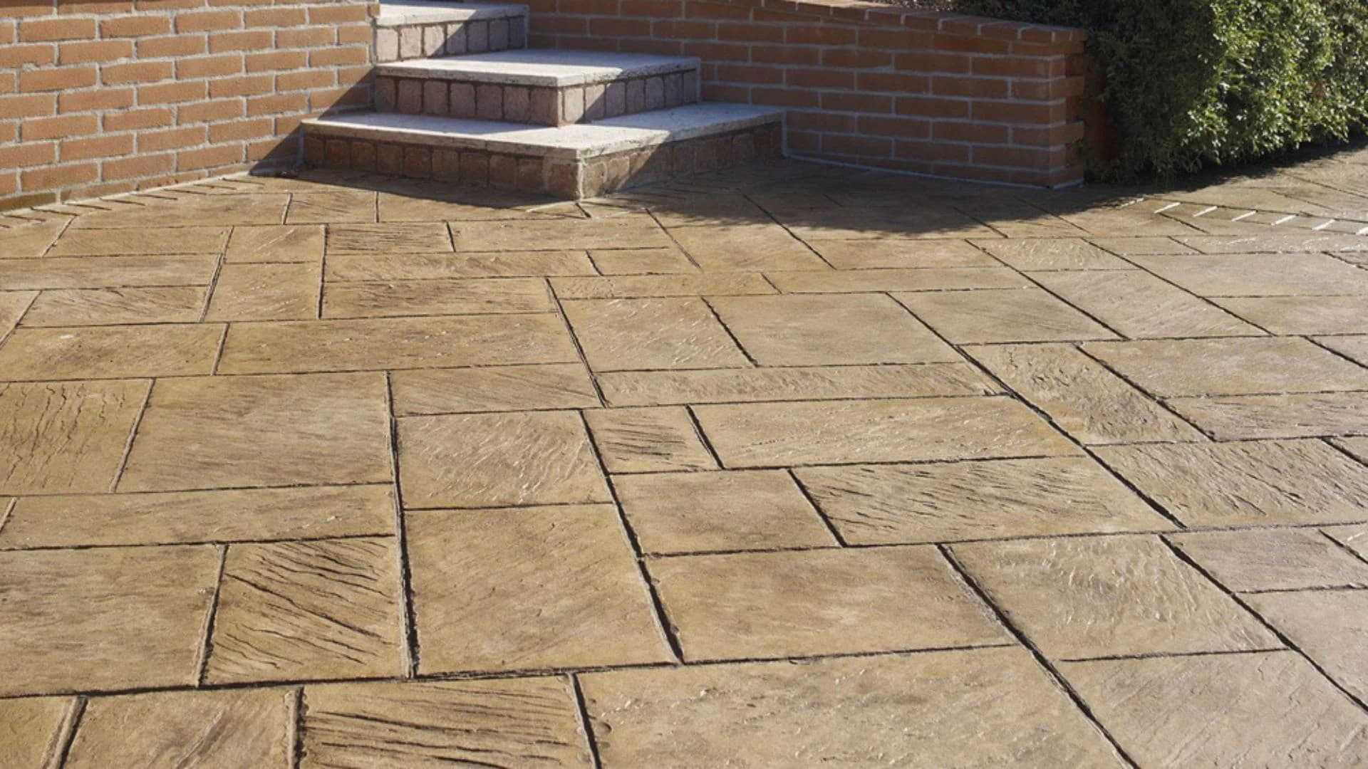 Stamped concrete flooring on an outdoor patio in Saudi Arabia with a natural stone pattern.