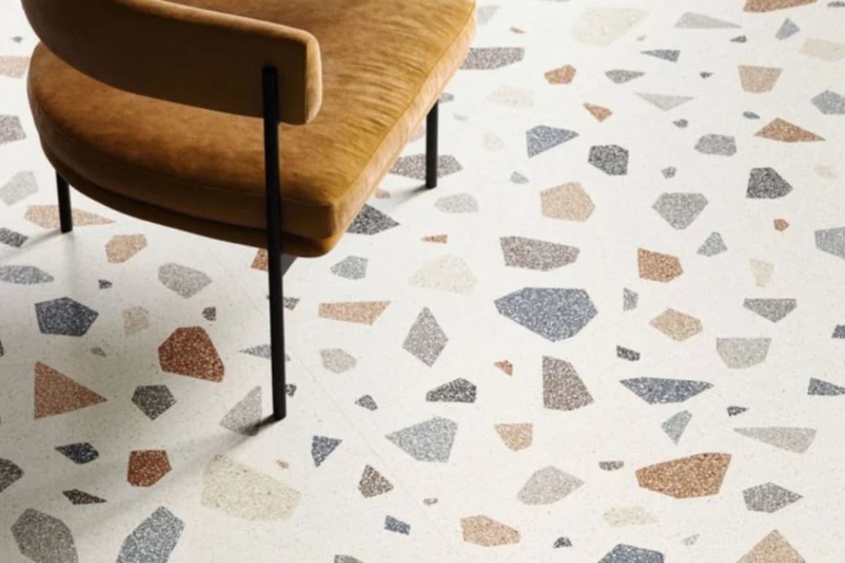 Stylish terrazzo flooring with large aggregate stone chips under a lounge chair in Dammam, Saudi Arabia